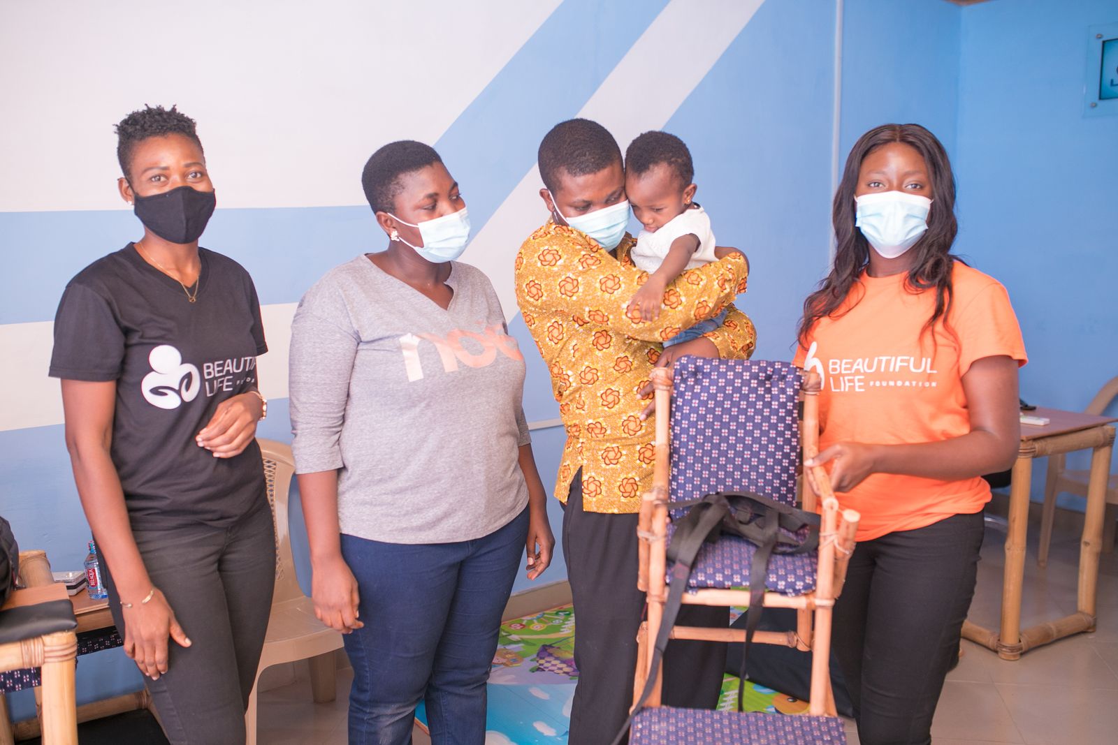 Foundation staff with a family and their child