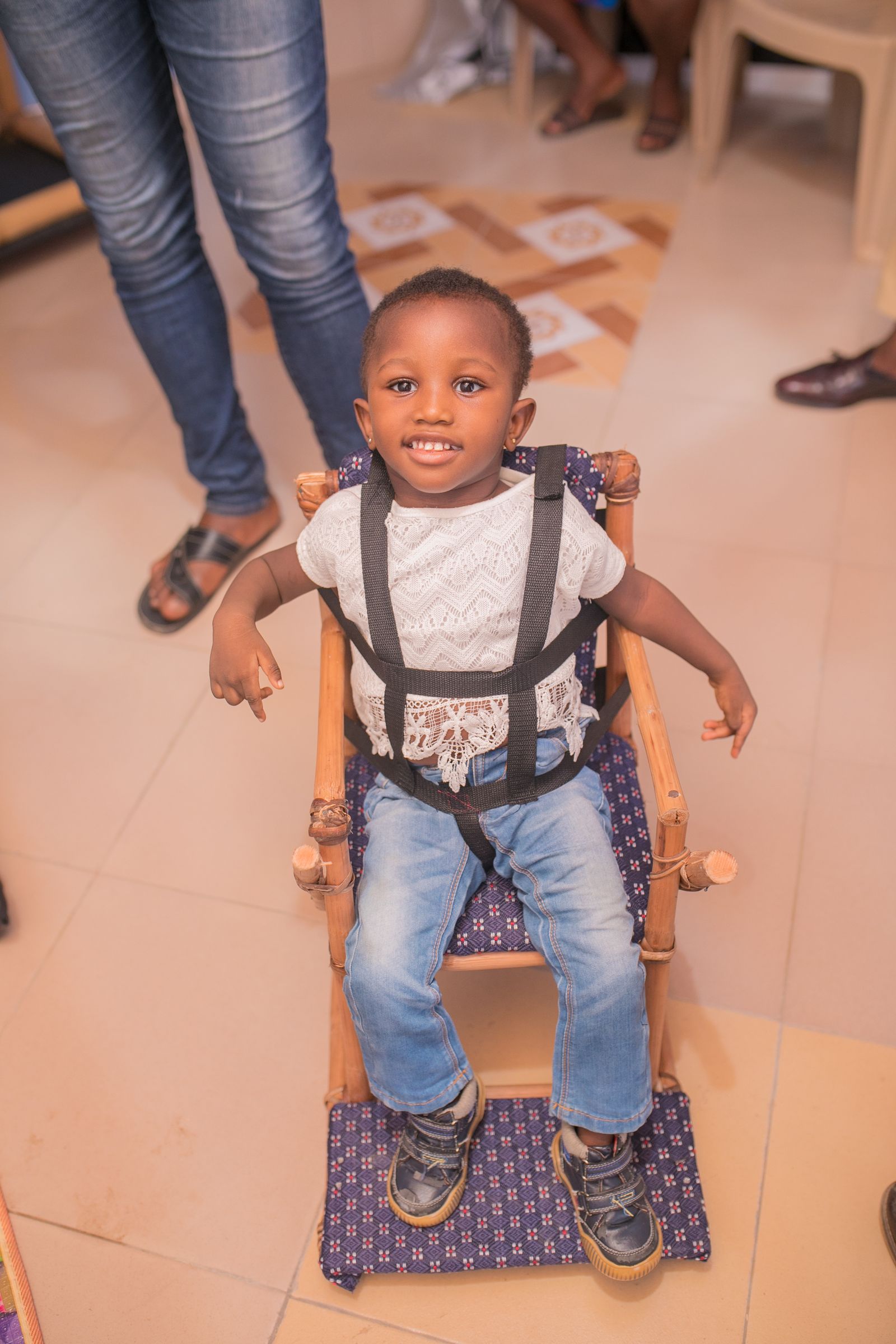 A child supported by the foundation standing in an adaptive frame
